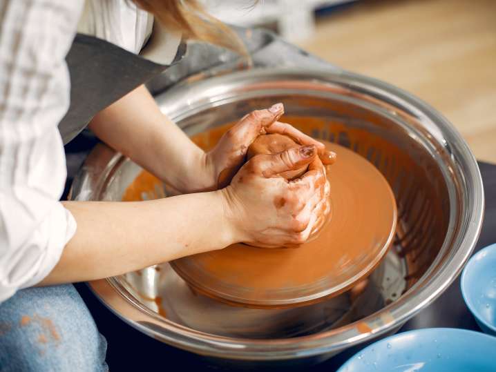 NYC - girl-making-vaze-from-clay-pottery-s-machine Shot
