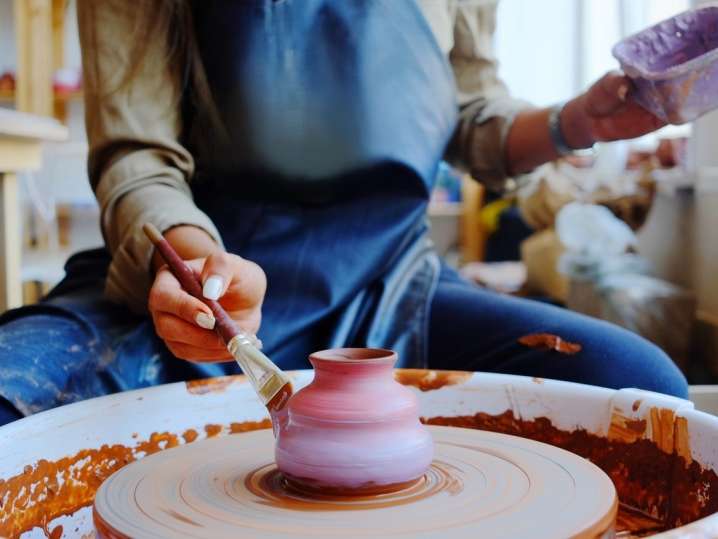 Chicago - students doing pottery painting on wheel Shot