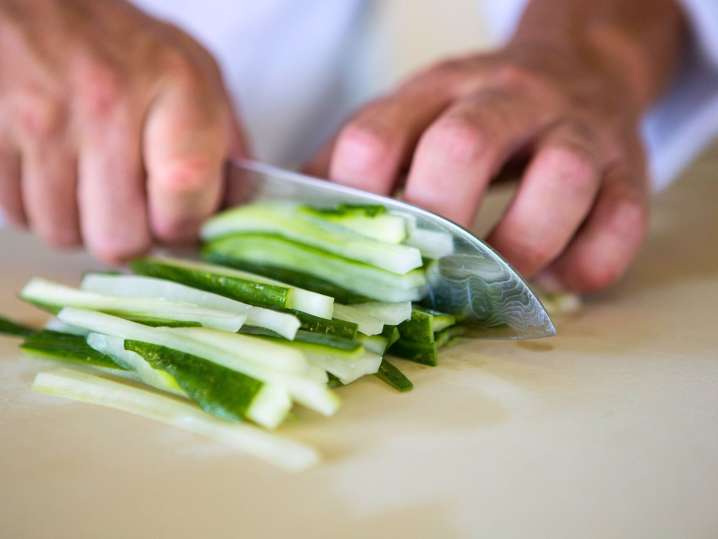 Philadelphia - cutting cucumber for sushi rolls Shot