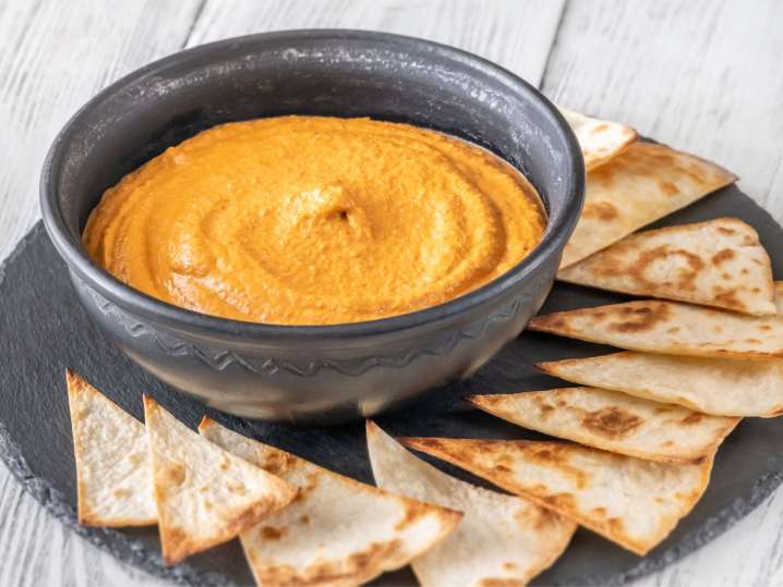 muhammara with pita bread on a dark plate Shot