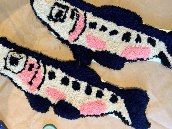 Boston - Close-up of tufted fish rugs with pink, black, and white details created during a DIY rug-making class Shot