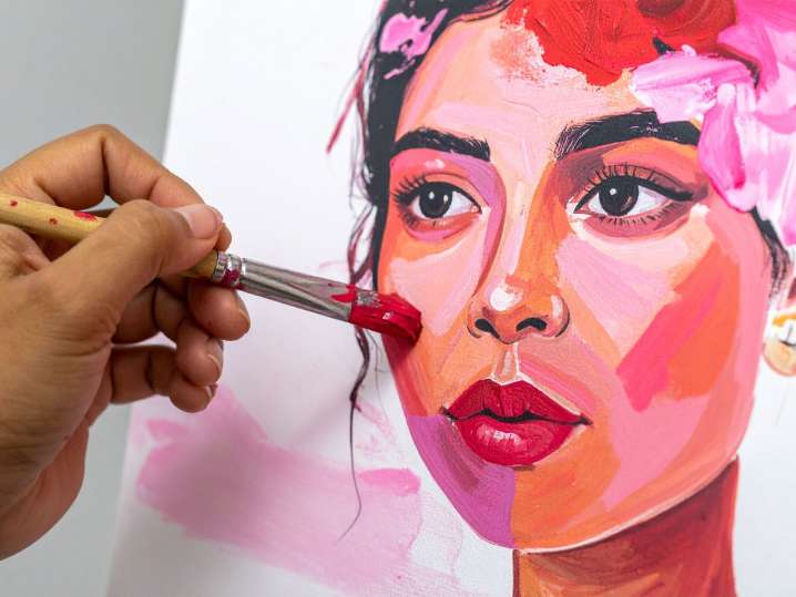 Portland - Artist painting a colorful portrait with expressive pink and orange tones Shot