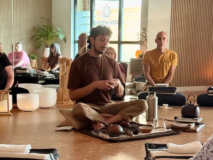 Portland - Instructor leading a seated group in a calm, mindful tea ceremony Shot