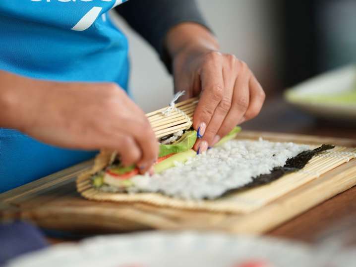 Chicago - a woman rolling sushi Shot