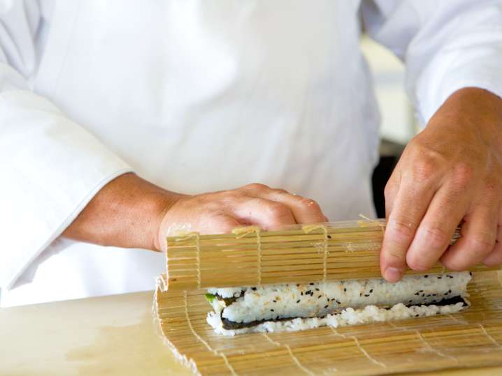 Fort Lauderdale - a chef rolling sushi in sushi class Shot