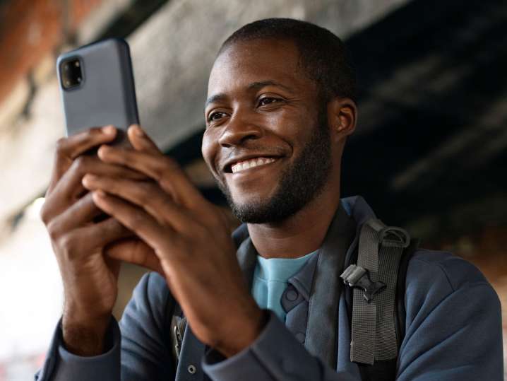 NYC - a man taking pictures with his phone Shot