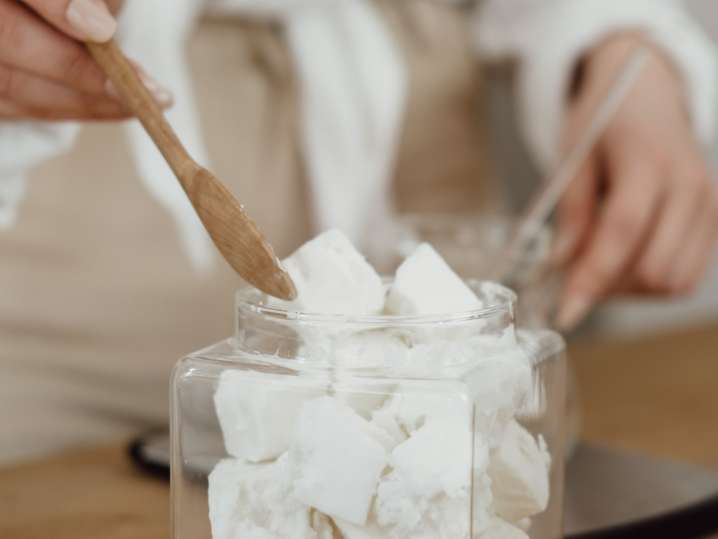 Los Angeles - Hands stirring chunks of wax in a pot Shot