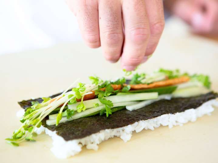 Dallas - a woman rolling sushi Shot