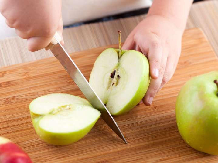 Raleigh - kid cutting apple Shot