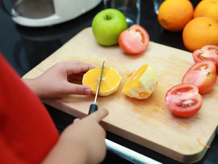 Charlotte - kids cutting fruits Shot