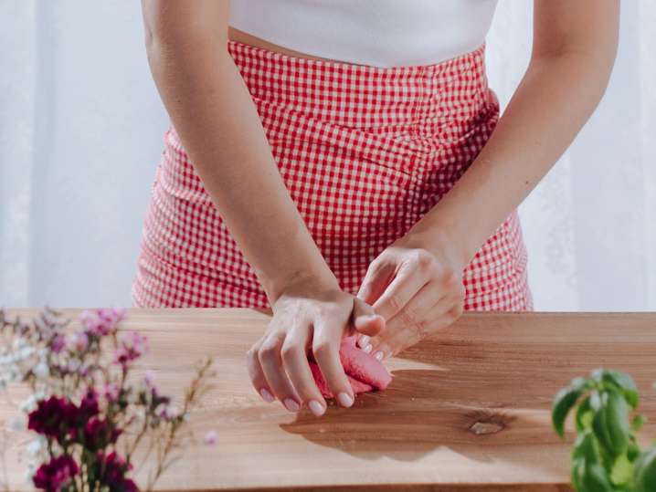 Sacramento - a woman making pink dough pasta Shot