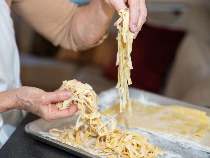Tulsa - Plating freshly cooked fettuccine pasta Shot