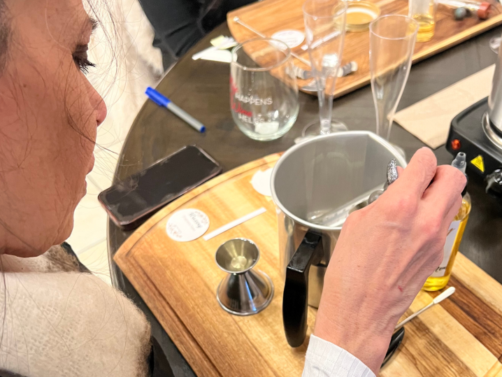 a woman pouring wax in a jar Shot