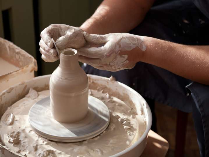 Boston - a man shaping a vase in wheel throwing pottery class Shot