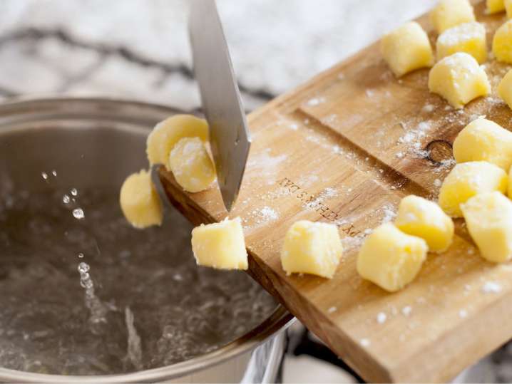 Houston - adding fresh gnocchi pasta to a pot with boiling water Shot