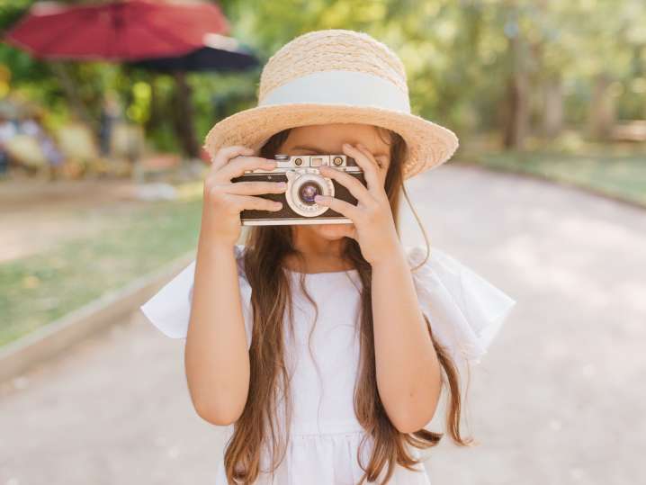 NYC - a girl taking a picture in a park Shot