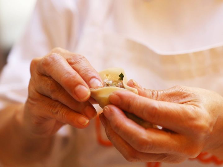 Bay Area - folding dumplings by hand Shot