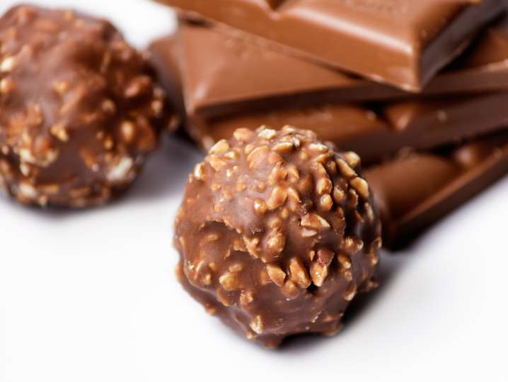 Bay Area - top-view-chocolate-candy-balls-with-chocolate-bars-white-surface Shot