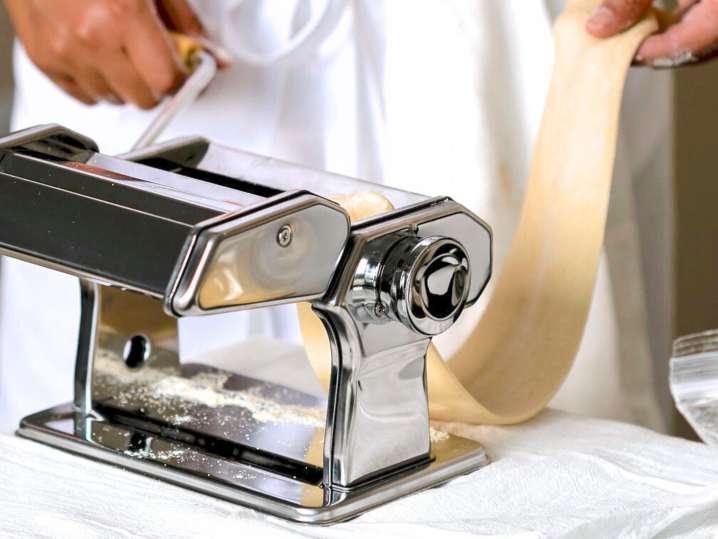Jersey City - chef passing pasta dough through pasta machine (2) Shot