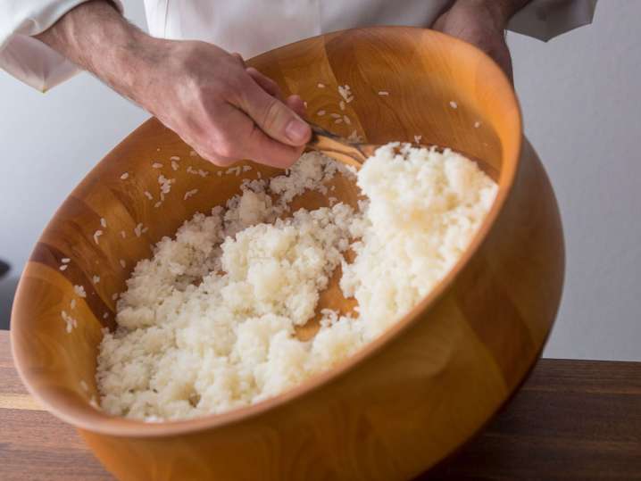 Houston - Chef mixing sushi rice in a large wooden bowl during class preparation Shot