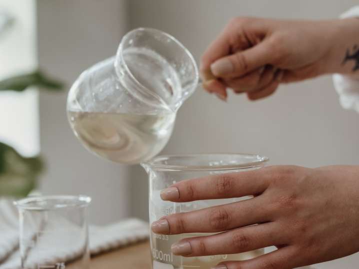Atlanta - Close-up of wax being poured into a glass jar Shot