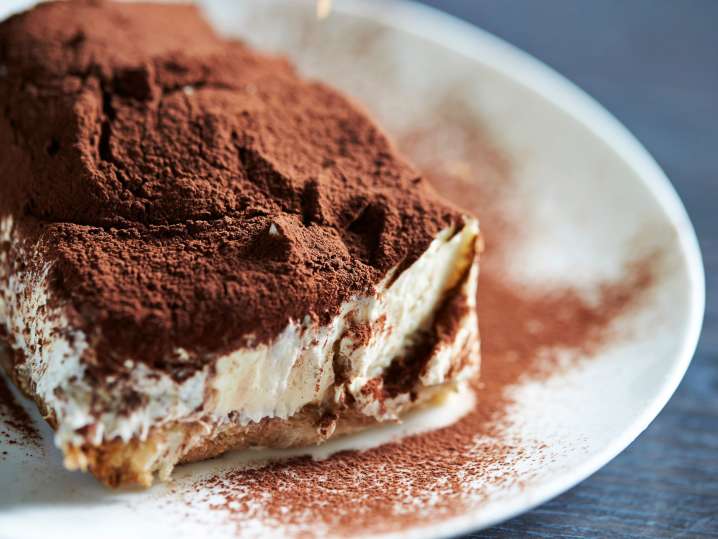indulgent Italian tiramisu creamy dessert on a white plate dusted with cacao | Classpop Shot
