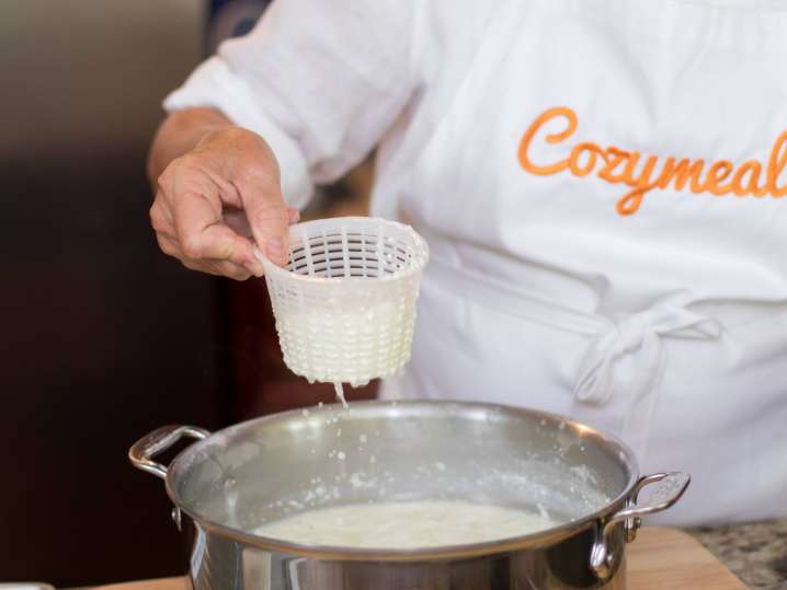 chef in Cozymeal apron making fresh ricotta cheese | Classpop Shot