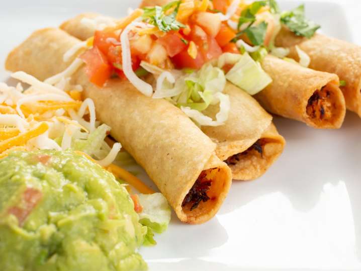 Chicken Tinga Taquitos with smashed avocado on the side and some garnish | Classpop Shot