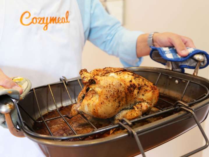 chef holding a tray with roasted whole chicken | Classpop Shot