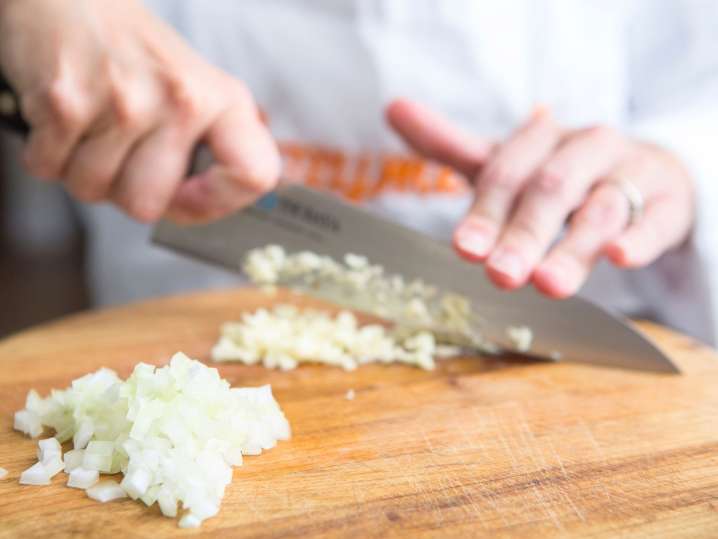 finely dicing onions on a wooden board | Classpop Shot