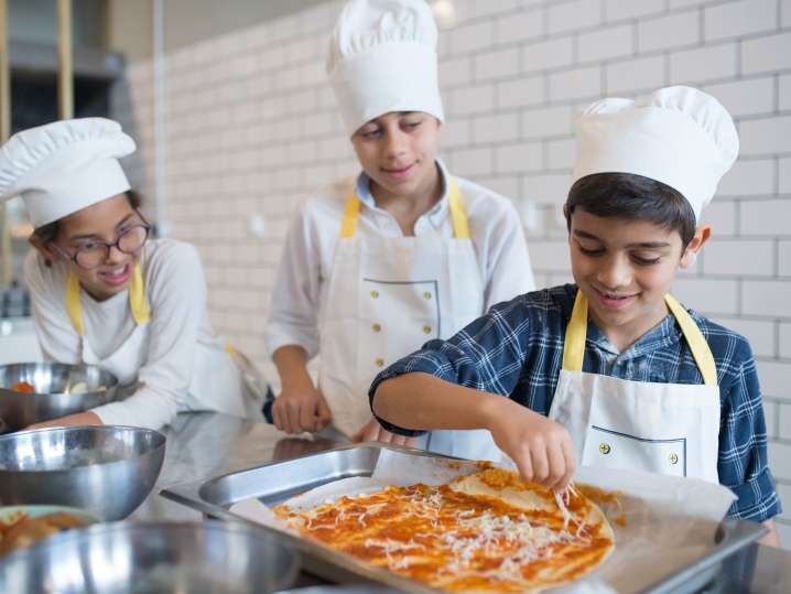 group of kids are preparing pizza for baking | Classpop Shot