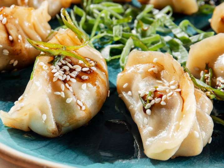 slightly crispy potsticker dumplings with sesame seed garnish | Classpop Shot