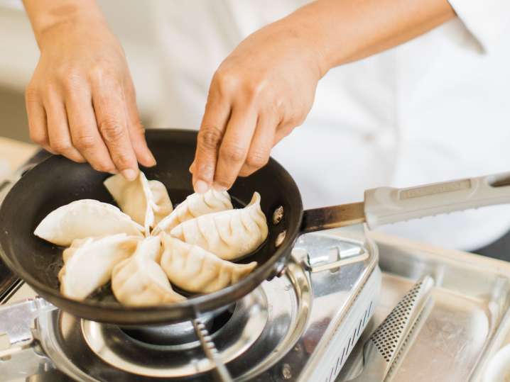 cooking potsticker dumplings in a pan | Classpop Shot