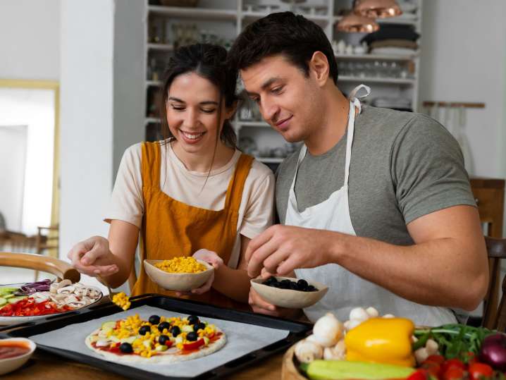 couple preparing fresh pizza with various toppings | Classpop Shot