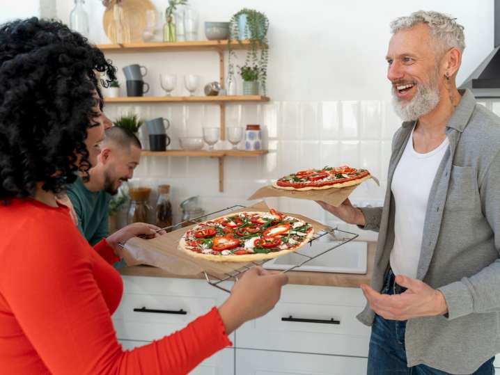 group of people making pizza together | Classpop Shot