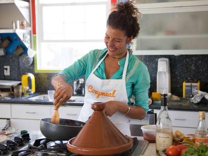 cooking tagine while wearing Cozymeal apron on | Classpop Shot