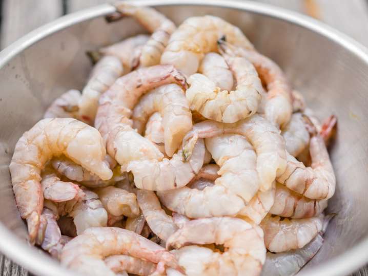 raw peeled shrimp in a metal bowl Shot