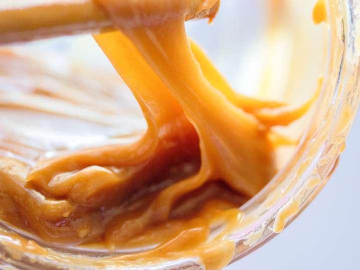 stirring a jar of homemade caramel Shot