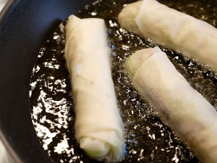 spring rolls frying in hot oil Shot