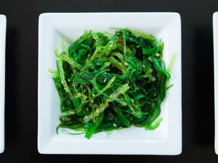 seaweed salad in a white bowl Shot