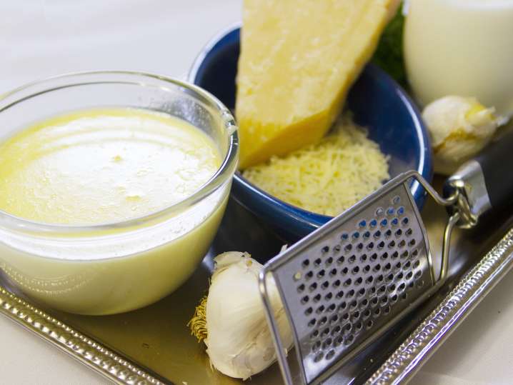 cheese, garlic, and butter on a tray for making macaroni and cheese Shot