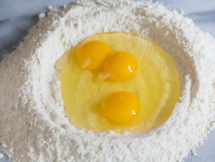 flour well with eggs to make fresh pasta dough Shot