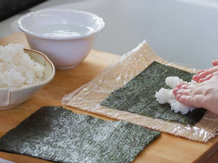 Austin - chef laying sushi rice on nori Shot
