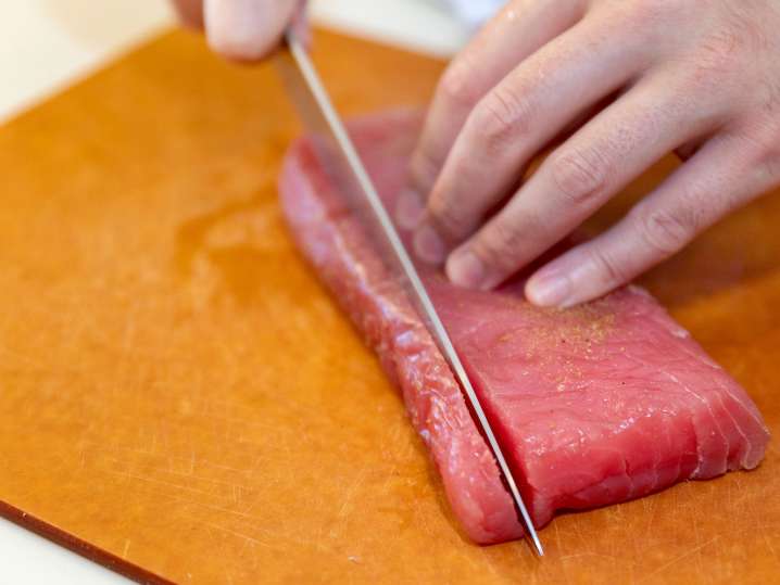 Houston - chef slicing sushi grade yellowtail tuna Shot