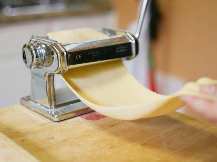 chef rolling a sheet of fresh pasta dough Shot