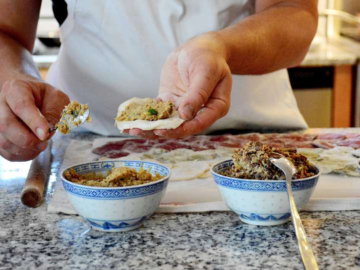 chef filling homemade potstickers Shot