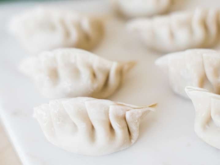 fresh filled dumplings on a cutting board Shot