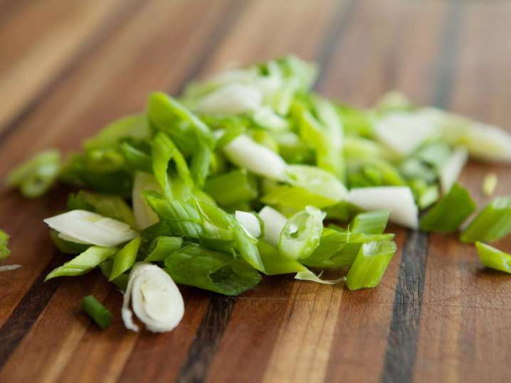 diced green onion on a cutting board Shot