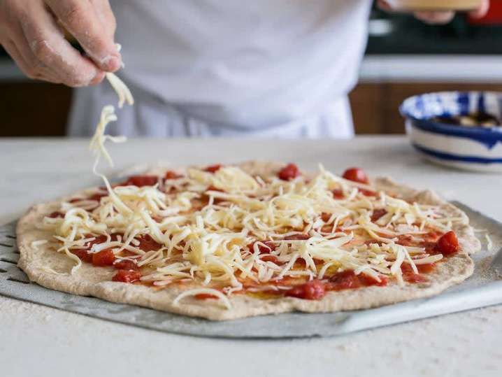 chef putting cheese on pizza | Classpop Shot