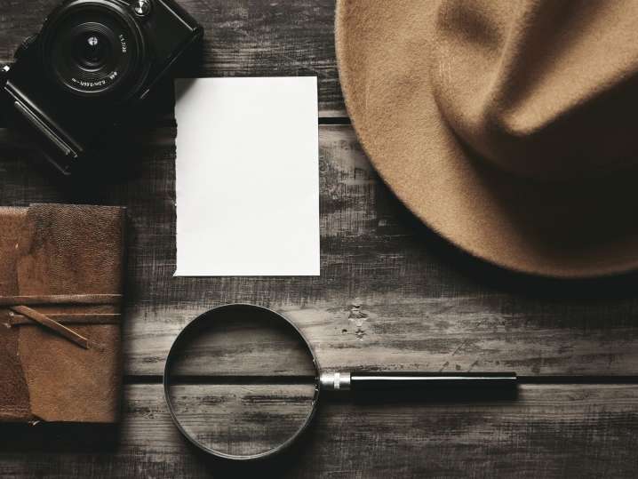 detective hat with magnifying glass and camera Shot